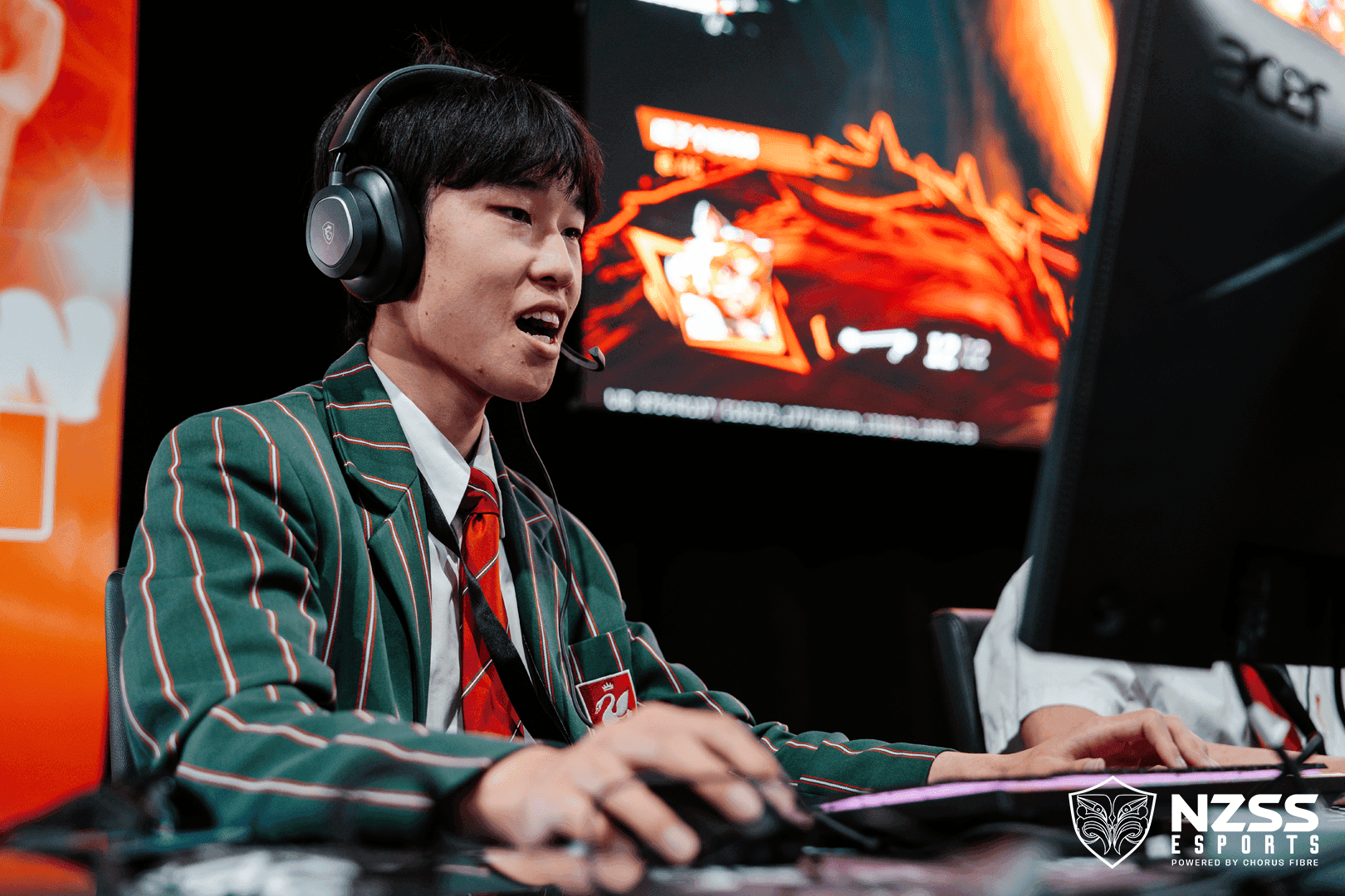 Students focused on a competitive match at a school esports event